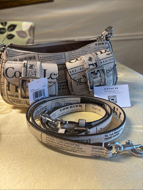 Coach Handbags - Coach Cream Newspaper Print Leather Crossbody Bag with Silver Buckles